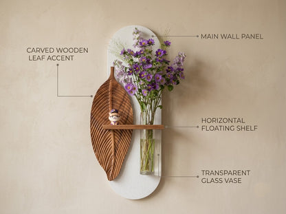 Wooden leaf wall art showing carved wood texture, oval panel and glass vase